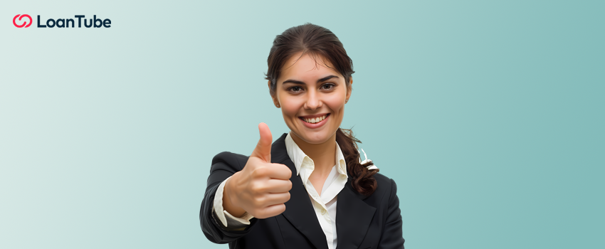 A woman with her thumb up symbolizing loan approval.